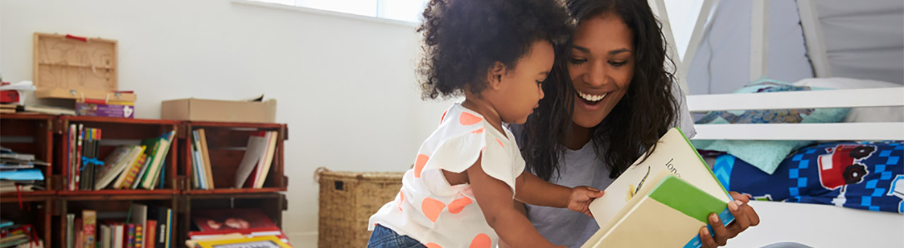 African-American-mom-reading-to-cute-toddler-girl