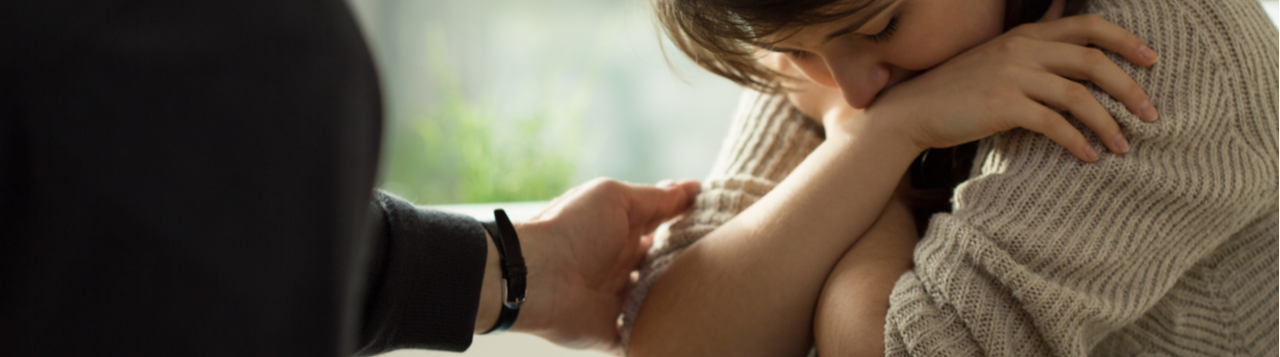 Young woman being comforted by friend