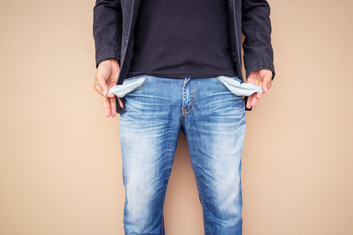 Man,Showing,His,Empty,Pockets,On,Cement,Background. Man,Showing,His,Empty,Pockets,On,Cement,Background.
