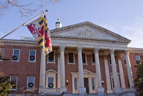 a flag hangs in front of the Maryland statehouse