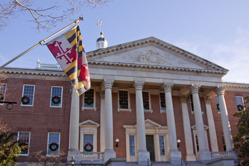 Maryland Statehouse with Flag a flag hangs in front of the Maryland statehouse